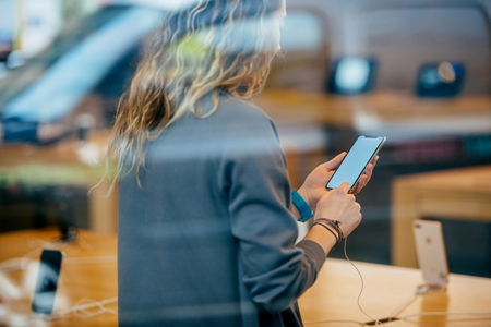 STRASBOURG, FRANCE - NOV 3, 2017: Street view of woman holding latest smartphone with blacnk screen - Apple iPhone X goes on sale in Apple Store worldwideのeditorial素材