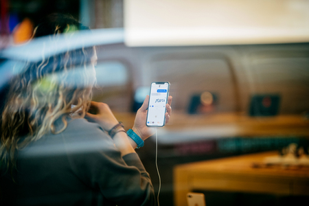 STRASBOURG, FRANCE - NOV 3, 2017: Street view of latest Apple iPhone X in Apple Store with woman using the iMessage Animoji and chat messageのeditorial素材