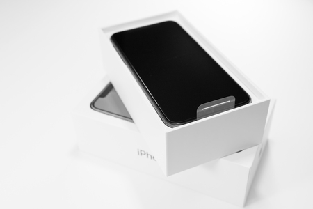 PARIS, FRANCE - NOV 3, 2017: Unboxing unpacking of the latest Apple iPhone X 10 smartphone on white table on the first day of saleのeditorial素材