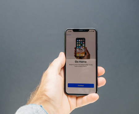 PARIS, FRANCE - NOV 3, 2017: New Apple iPhone X 10 smartphone first run with hand accepting Go Home messageのeditorial素材