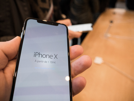 STRASBOURG, FRANCE - NOV 3, 2017: POV point of view of customer holding iphone X and its price of 1159 Euros in Europeのeditorial素材