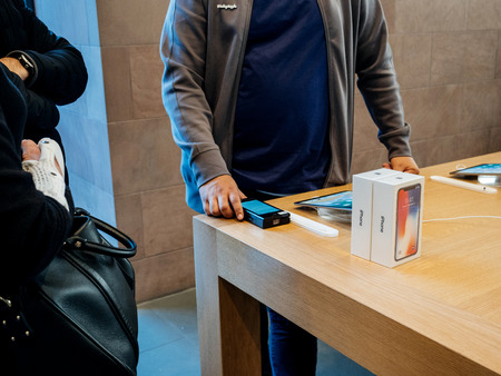 STRASBOURG, FRANCE - NOV 3, 2017: Seller scanning barcode of the latest iPhone X 10 smartphone before purchase at Apple Store Computersのeditorial素材
