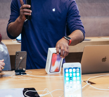 STRASBOURG, FRANCE - NOV 3, 2017: Black ethnicity seller scanning the Apple iPhone X 10 box before sale to customersのeditorial素材