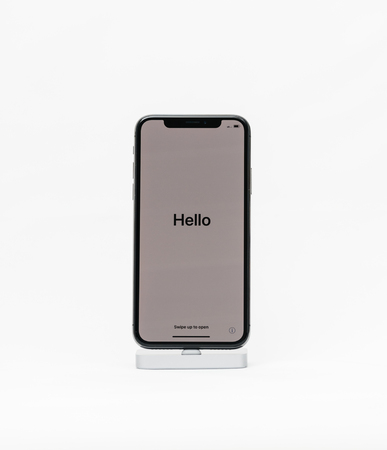 PARIS, FRANCE - NOV 5, 2017: New Apple iPhone X 10 isolated white background with Hello word welcome during the first run of the smartphoneのeditorial素材