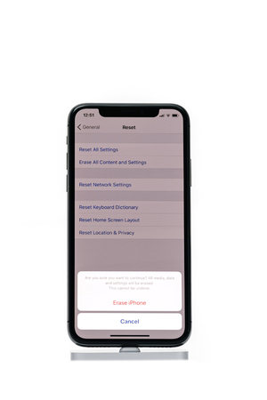 PARIS, FRANCE - NOV 5, 2017: New Apple iPhone X 10 smartphone isolated white background with Erase Reset iPhone messageのeditorial素材