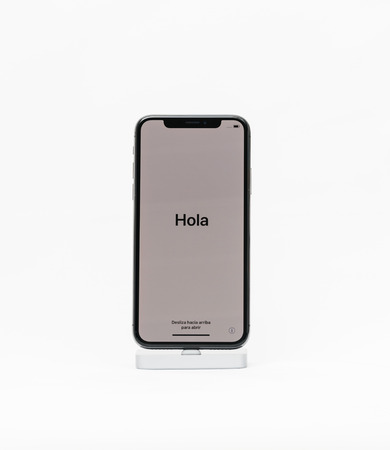 PARIS, FRANCE - NOV 5, 2017: New Apple iPhone X 10 isolated white background with Hola in Spanish translated as Hello - first run installationのeditorial素材