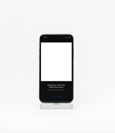 PARIS, FRANCE - NOV 5, 2017: New Apple iPhone X 10 smartphone isolated white background reposition your face within the frame Face ID with blank spaceのeditorial素材