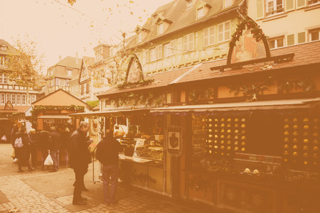 COLMAR, FRANCE - NOV 23, 2014: Vintage effect over Christmas Market of Colmar, Alsace with tourists and locals buying gifts and sweetsのeditorial素材