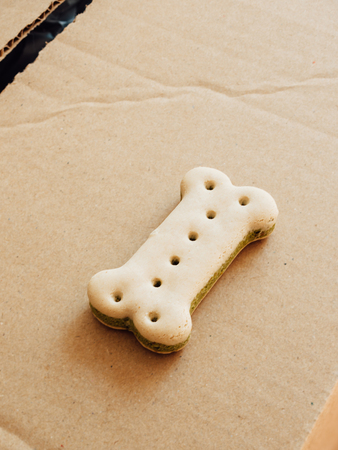 Bone shaped dry pet doog food on a cardboard boxの写真素材