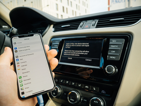 FRANKFURT, GERMANY - NOV 4, 2017: Man connecting his new iPhone X 10 to the navigation system of the car with CarPlay - message on GPS - new device detectedのeditorial素材