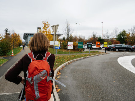 BASEL, SWITZERLAND -NOV 11, 2017: Woman walking to the EuroAirport Basel Mulhouse Freiburg building...