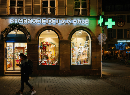 STRASBOURG, FRANCE - NOV 21, 2017: Pharmacie de la Vierge pharmacy neon sign on Christmas decorated facade in Strasbourg, Alsaceのeditorial素材