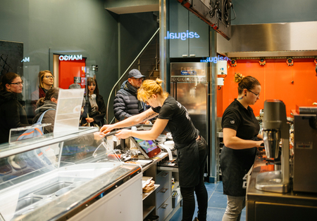STRASBOURG, FRANCE - NOV 21, 2017: Workers people inside a waffle making shop, view behind the counter preparing food for customersのeditorial素材