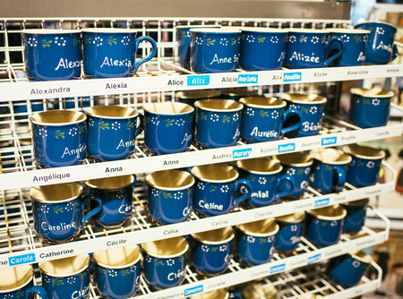 STRASBOURG, FRANCE - NOV 21, 2017: Souvenir ceramic mugs with hand painted French female names for sale on Strasbourg streets during the Christmas Marketのeditorial素材