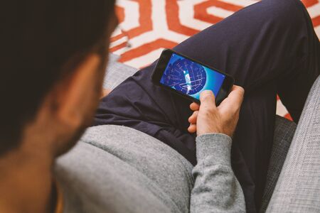PARIS, FRANCE - NOV 8, 2017: Man playing arcade war game on the new Apple Computers iPhone Xのeditorial素材
