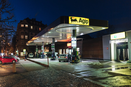 STRASBOURG, FRANCE - NOV 29, 2017: AGIP Gas station in France at night with people customers refueling cars and empty carwash nearby. Agip is part of the ENI Groupのeditorial素材