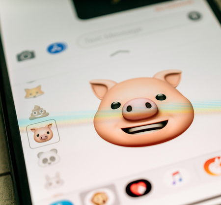 PARIS, FRANCE - NOV 9 2017: Pig animal 3d animoji emoji generated by Face ID facial recognition system with happy smile face emotion close-up of the new iphone X 10 Display - tilt-shift lens usedのeditorial素材