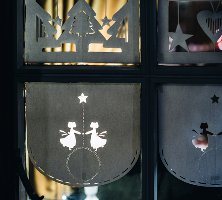 Paper decorations on the windows of a Christmas house in Strasbourg, Alsace France during Christmas Marketの写真素材