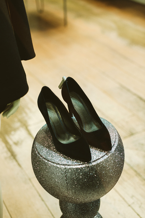 Leather heels business office type on sparkling disco ball glass christmas winter holiday decorationの写真素材