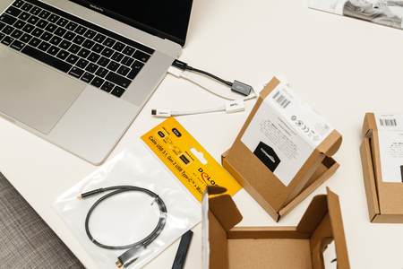 PARIS, FRANCE - JAN 23, 2018: Apple MacBook Pro 15 laptop on table with multiple packages boxes with cables from Amazon basics USB-C to  Adapterのeditorial素材
