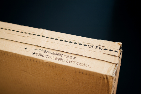 PARIS, FRANCE - APR 9, 2017: Cardboard box from Amazon.co.jp with distinct online retailer insignia and japanese hieroglyphsのeditorial素材