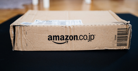 PARIS, FRANCE - APR 9, 2017: Side view of cardboard box from Amazon.co.jp with distinct online retailer insigniaのeditorial素材