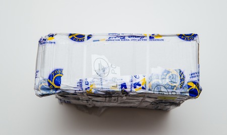 PARIS, FRANCE - JAN 9 2017: Broken parcel covered with safety scotch adhesive band from Posta Moldovei, Moldovan postal service - white table backgroundのeditorial素材