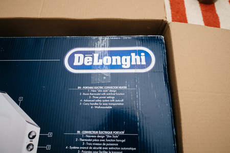 PARIS, FRANCE - FEB 7, 2018: Unboxing large cardboard box containing italian DeLonghi air convection heater bought from Amazon Warehouse Dealsのeditorial素材