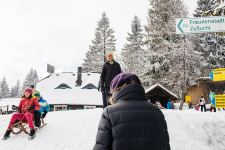SEEBACH MUMMELSEE, GERMANY - FEB 18, 2018: Happy kids sleighing the sledding slope on a sunny winter dayのeditorial素材