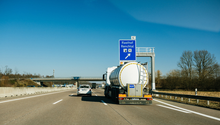 BADEN WURTTEMBERG, GERMANY - FEB 25, 2018: Driver point of view POV at the driving in front large cistern truck transporting milk from Polandのeditorial素材