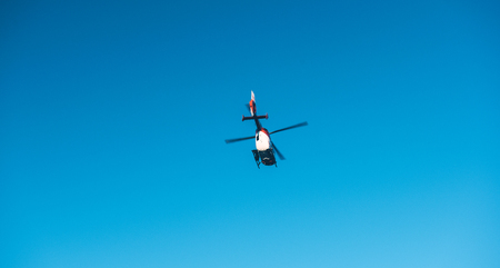 BADEN WURTTEMBERG, GERMANY - FEB 25, 2018: View from below of rescue helicopter DRF Luftrettung flying in clear blue sky transporting a victim to hospitalのeditorial素材