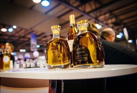 STRASBOURG, FRANCE - FEB 19, 2018: Bootles of Napoleon Cognac VSOP French wine at the Vignerons independant English: Independent winemakers of France wine fair in Strasbourgのeditorial素材