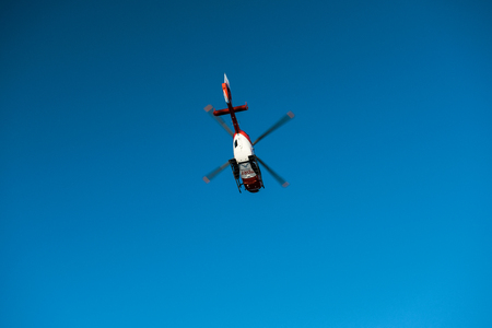 BADEN WURTTEMBERG, GERMANY - FEB 25, 2018: Rescue helicopter DRF Luftrettung flying in clear blue sky transporting a victim to hospitalのeditorial素材