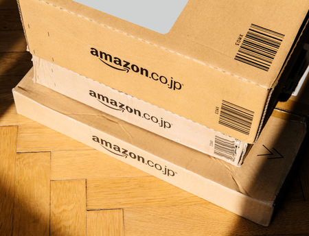 PARIS, FRANCE - FEB 21, 2018: View from above of three Amazon Prime Japan boxes stack on wooden backgroundのeditorial素材