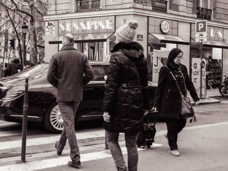 PARIS, FRANCE - JAN 30, 2018: French male and female crossing street in front of Mercedes -Benz luxury limousine in Paris, on the Rue St Vincent de Paulのeditorial素材