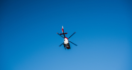 BADEN WURTTEMBERG, GERMANY - FEB 25, 2018: View from below of rescue helicopter from DRF Luftrettung German foundation flying in clear blue skyのeditorial素材