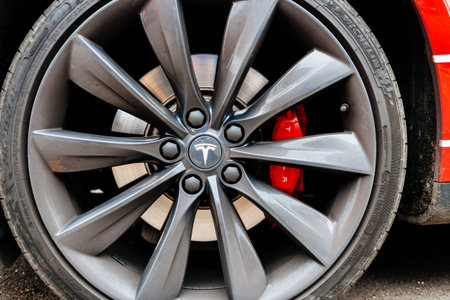 PARIS, FRANCE - NOV 29, 2014: Close-up of aluminium rim of luxury electric Tesla Model S car wheel...