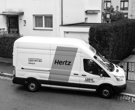PARIS, FRANCE - SEP 13, 2017: White HERTZ rent a van service seen from above on a French street near a houseのeditorial素材
