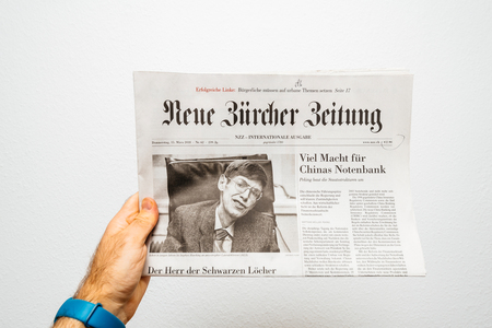 PARIS, FRANCE - MAR 15, 2018: POV at Swiss Neue Burcher Zeitung newspaper with portrait of Stephen Hawking the English theoretical physicist, cosmologist dead on 14 March 2018のeditorial素材