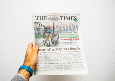 PARIS, FRANCE - MAR 19, 2018: Hand holding British newspaper The Times with portrait of Stephen Hawking the English theoretical physicist, cosmologist dead on 14 March 2018のeditorial素材