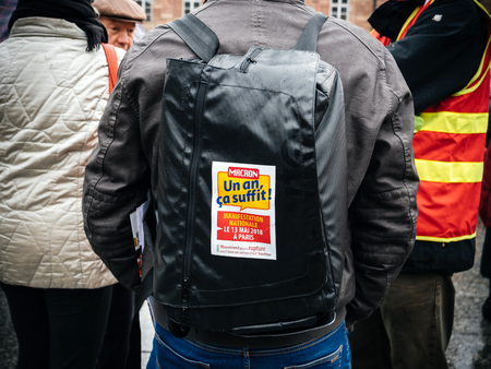 STRASBOURG, FRANCE  - MAR 22, 2018: Macron, a year is neough sticker on backpack at demonstration protest against Macron French government string of reforms,のeditorial素材