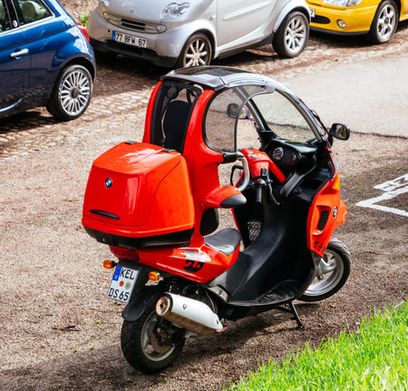 PARIS, FRANCE - CIRCA 2018: BMW C1 enclosed scooter manufactured by Bertone for BMW - red on the...