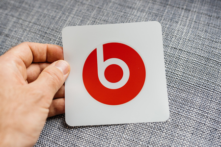 PARIS, FRANCE - MAR 31, 2018: Man unboxing new Apple Beats By Dr Dre Beats Wireless headphones looking at the red iconic stickerのeditorial素材