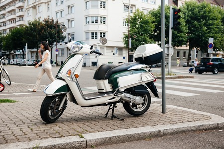 PARIS, FRANCE - JUN 27, 2015: Side view of modern Piaggio scooter parked on a French streetのeditorial素材