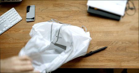 PARIS, FRANCE - APR 12 2018: POV man unboxing unpacking latest Apple Watch Series 3 GPS LTE smartwatch  taking the box from the iconic plastic filmのeditorial素材