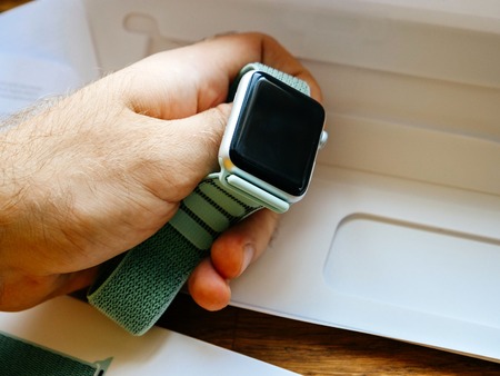 PARIS, FRANCE - APR 24, 2018: Man holding New Apple Watch Series 3 smartwatch personal wearable device - black screenのeditorial素材