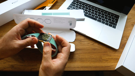 PARIS, FRANCE - APR 24, 2018: New Apple Watch Series 3 smartwatch change strap to the new 42mm Marine Green Sport Loop - installing the strap on the Apple Watchのeditorial素材