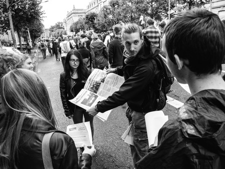 STRASBOURG, FRANCE - SEP 12, 2018: Man distributing manifests flyers newspapers during a French Nationwide day of protest against labor reform proposed by Emmanuel Macron Governmentのeditorial素材