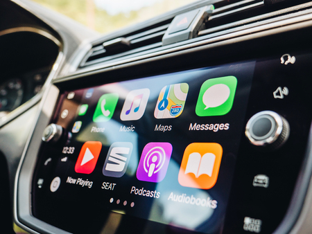 PALMA DE MALLORCA, SPAIN - MAY 10, 2018: Side view of large dashboard computer screen with apps buttons on the Apple CarPlay main screen in modern car dashboardのeditorial素材
