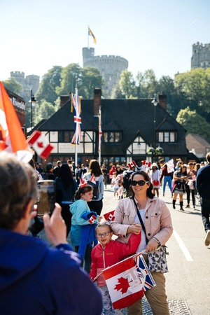 WINDSOR, BERKSHIRE, UNITED KINGDOM - MAY 19, 2018: Canadians tourist taking photo during royal wedding marriage celebration of Prince Harry, Duke of Sussex and the Duchess of Sussex Meghan Markle in happy romantic best atmosphereのeditorial素材